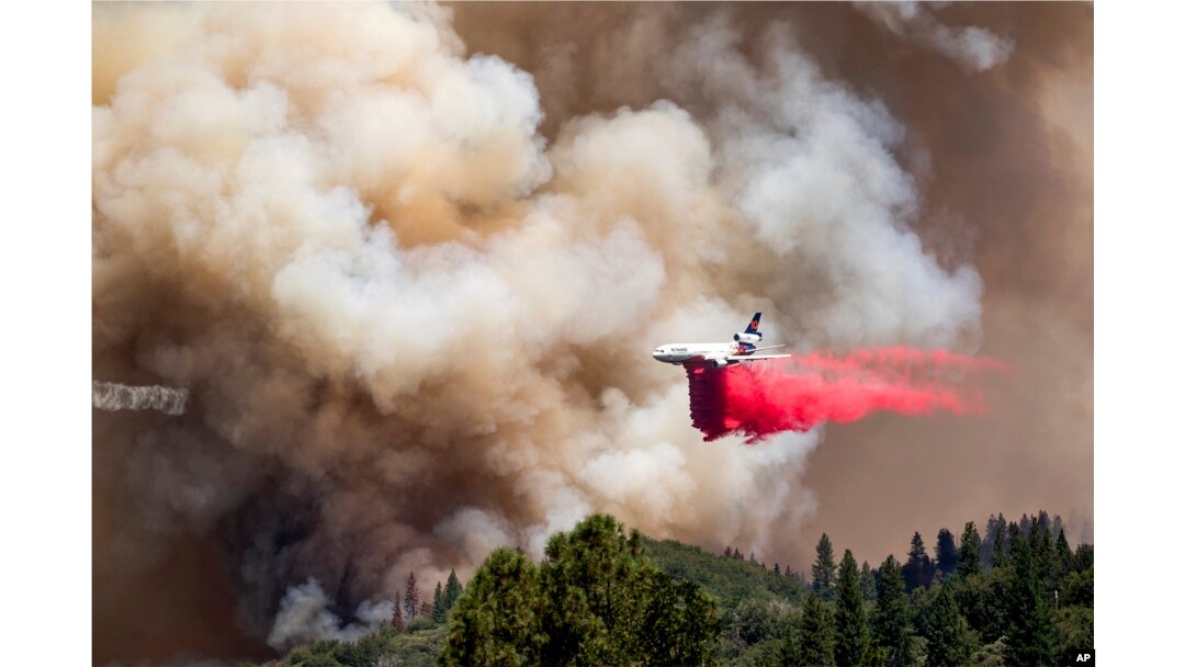 FILE - An air tanker drops retardant while trying to stop the Oak Fire from progressing in Mariposa County, California, on July 24, 2022.