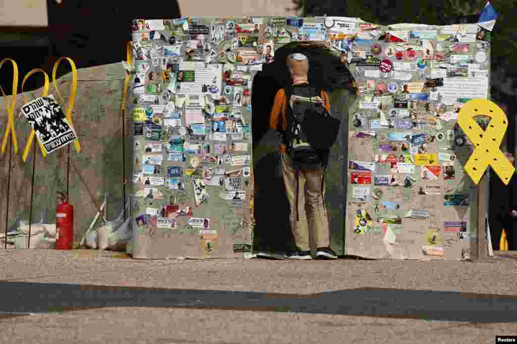 A person enters a makeshift tunnel symbolizing Hamas tunnels, built in support of the hostages kidnapped during the deadly October 7, 2023 attack by Hamas and who are still held in captivity, at the so-called "Hostages Square" in Tel Aviv, Israel.