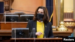 FILE - Michigan Gov. Gretchen Whitmer addresses the state’s Electoral College at the state Capitol in Lansing, Michigan, Dec. 14, 2020. 