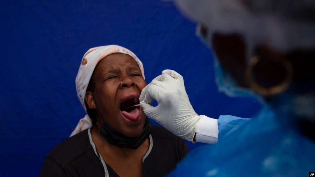 A patient gets a throat swab to test for COVID-19 at a facility in Soweto, South Africa, Dec. 2, 2021. 