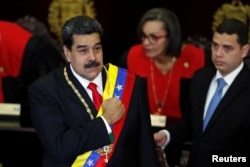 FILE - Venezuela's President Nicolas Maduro gestures during a ceremony to mark the opening of the judicial year at the Supreme Court of Justice in Caracas, Venezuela, Jan. 24, 2019.
