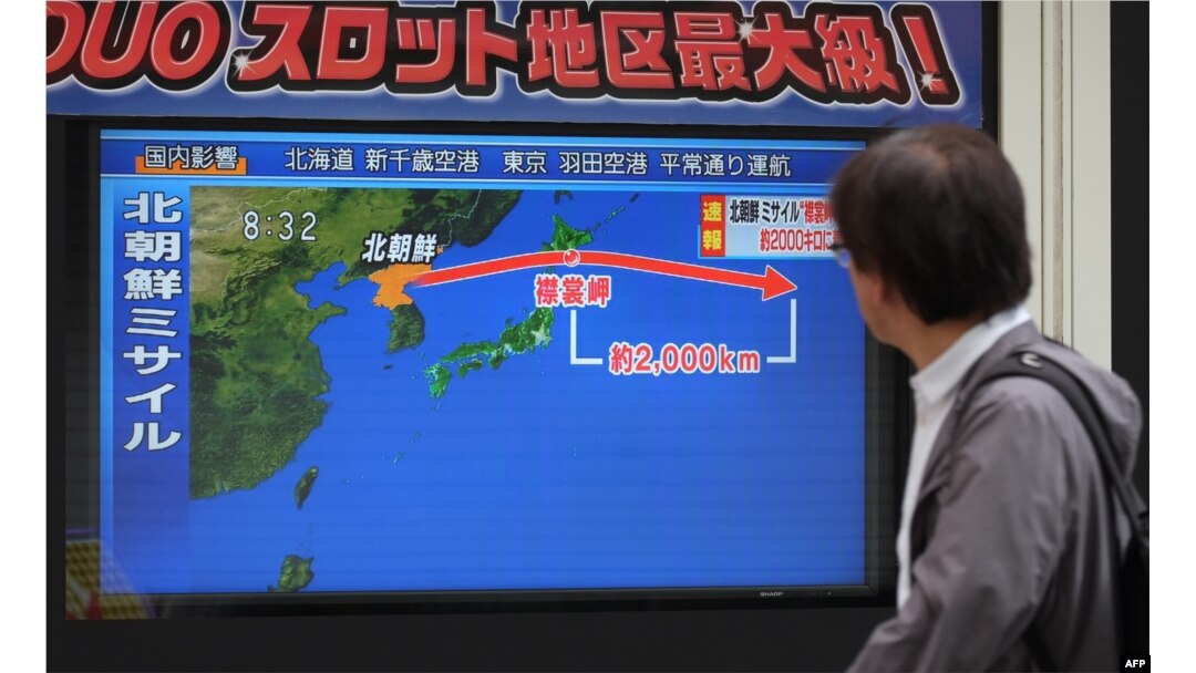 FILE - A pedestrian looks at a television screen displaying a map of Japan, right, and the Korean Peninsula in Tokyo, following a North Korean missile test that passed over Japan, Sept. 15, 2017.
