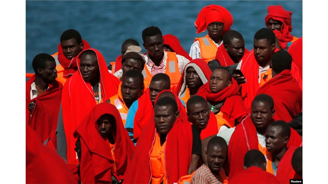 FILE- Migrants, part of a group intercepted aboard two dinghies off the coast in the Mediterranean Sea, stand on a rescue boat upon arrival at the port of Malaga, Spain, June 9, 2018.