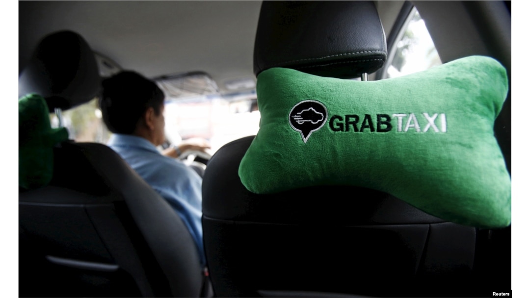 A GrabTaxi logo is seen on a car neck pillow in a taxi in Hanoi, Vietnam Sept. 9, 2015.