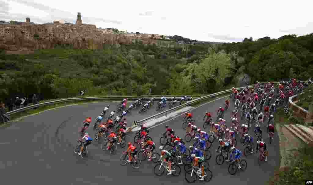 The peloton rides past Pitigliano during stage four of the 102nd Tour of Italy cycle race, 235 kilomters from Orbetello, to Frascati.