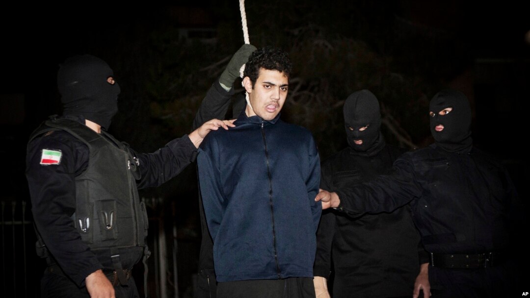 FILE - Iranian policemen prepare to hang a young convict in Tehran, Iran, Jan. 20, 2013. 