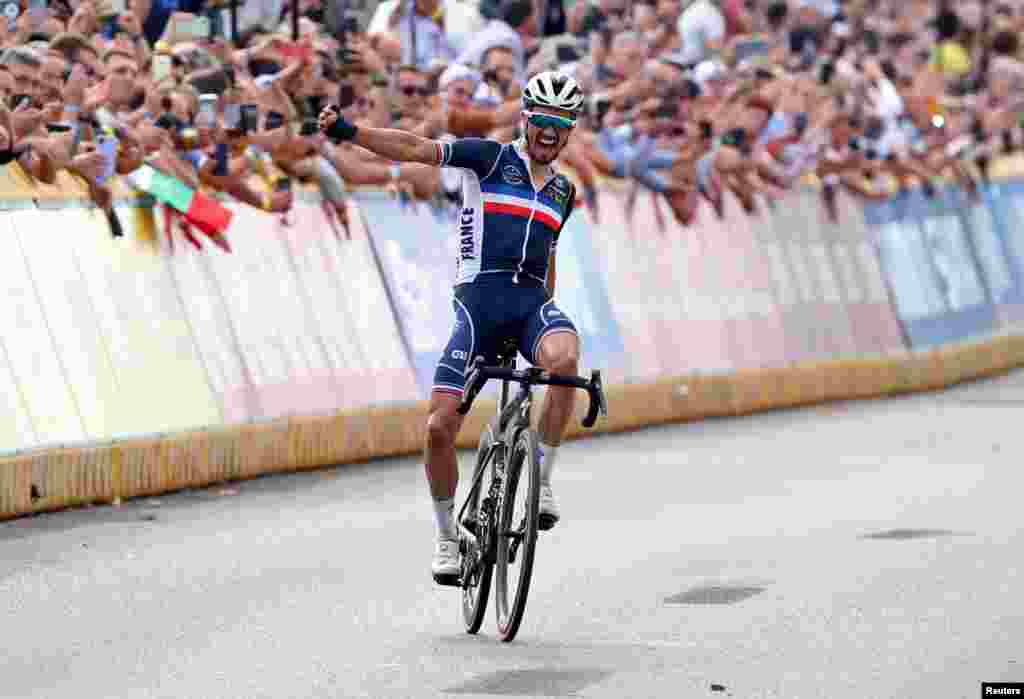 Julian Alaphilippe fo France celebrates as he crosses the finish line to win the cycling road race during the Flanders 2021 UCI Road World Championships in Leuven, Belgium.