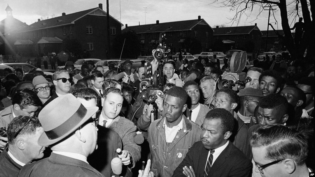 Wilson Baker, left foreground, public safety director, warns of the dangers of night demonstrations at the start of a march in Selma, Alabama, Feb. 23, 1965.