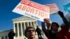FILE - Abortion rights activists protest outside of the U.S. Supreme Court, during the March for Life in Washington, Jan. 18, 2019. 