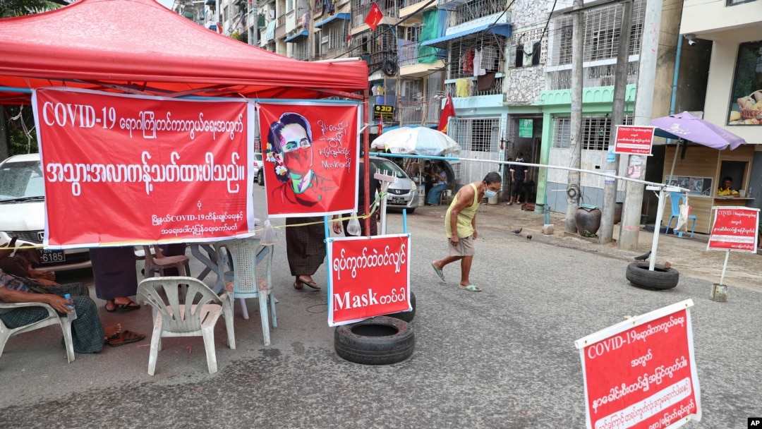 A man walks on a blocked street in an area locked down to curb the spread of the coronavirus, in Yangon, Myanmar, Sept. 11, 2020.