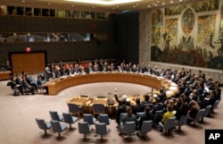 FILE - The United Nations Security Council votes on a resolution during a meeting at U.N. headquarters, March 2, 2016.