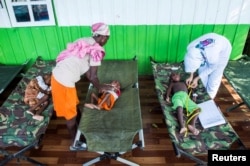 FILE - Sick children are treated by health workers at a hospital in Agats, Asmat District, after the government dispatched military and medical personnel to the remote region of Papua to combat malnutrition and measles, Jan. 22, 2018.