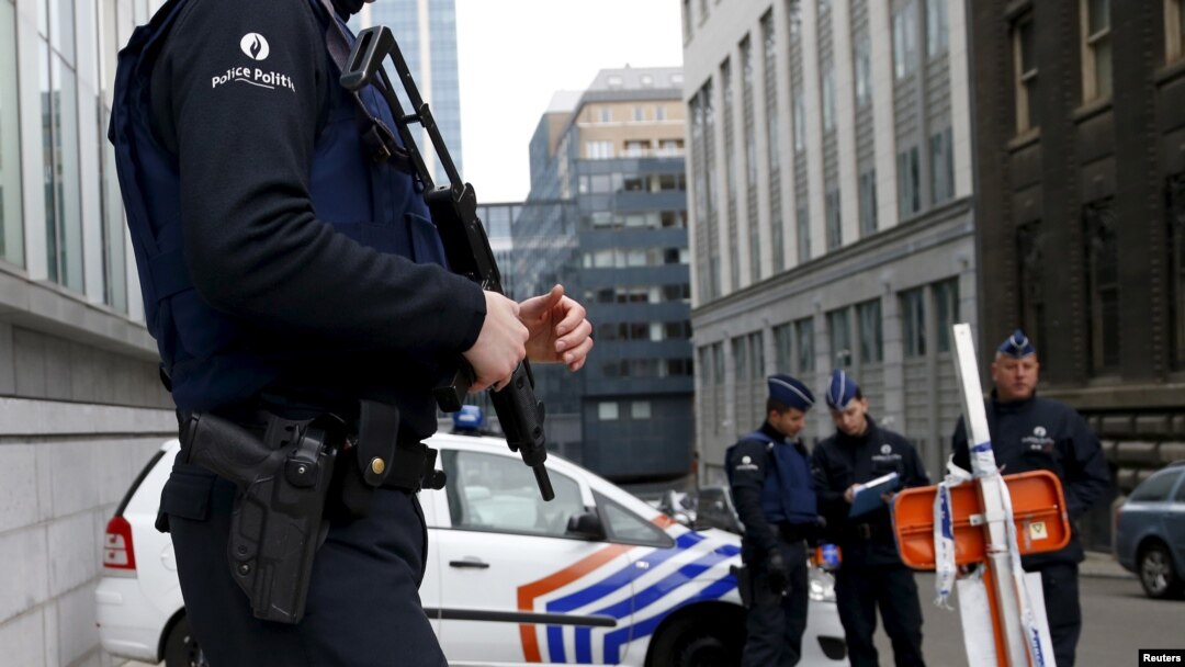 FILE - Belgian police officers secure an access to the federal police headquarters in Brussels, March 19, 2016, after Salah Abdeslam, the most-wanted fugitive from November's Paris attacks, was arrested after a shootout with police in Brussels on Friday.