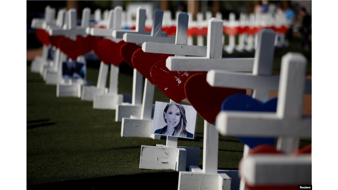 A photograph hangs from one of the 58 white crosses set up for the victims of the Route 91 music festival mass shooting in Las Vegas, Nevada, Oct. 5, 2017.