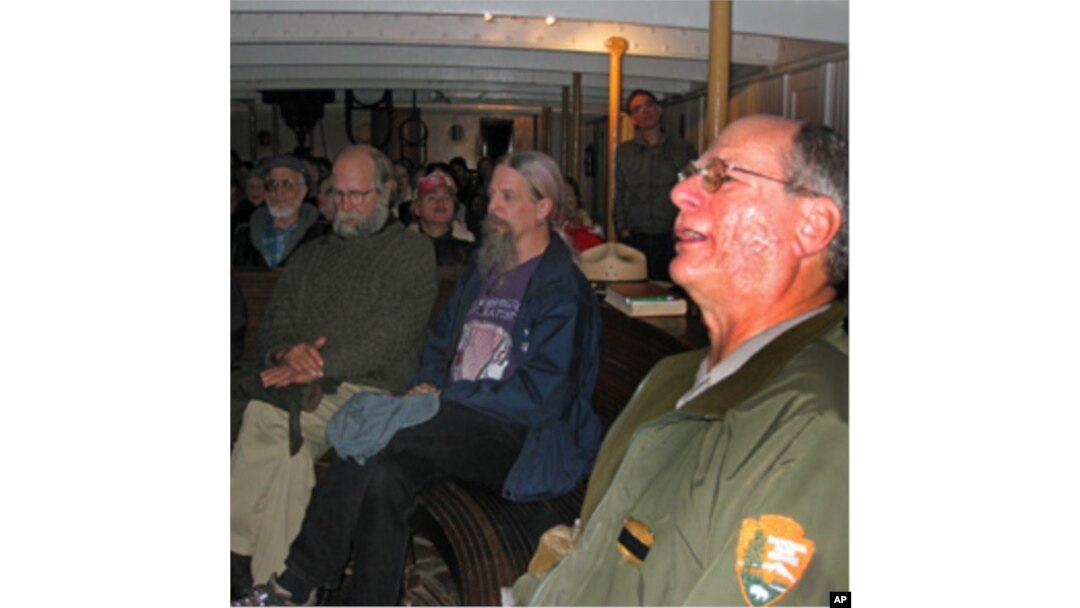 Park ranger Peter Kasin (right) leads a sea chantey sing-along aboard the 1886 sailing ship, The Balclutha.