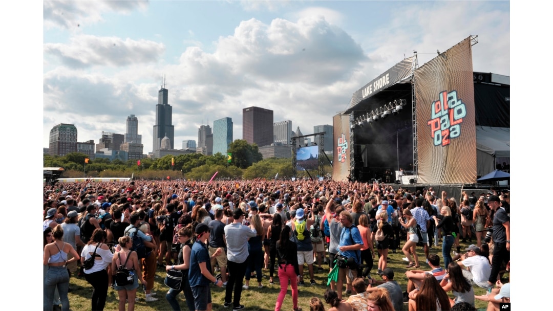 Fans watch day four performances as Charli XCX performs on day four at Lollapalooza in Grant Park, Aug 6, 2017 in Chicago. According to reports, the Las Vegas gunman also reserved rooms in Chicago, overlooking the Lollapalooza festival, but he did not check in.
