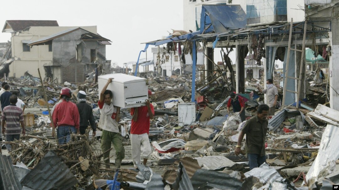 Tsunami survivors carry items they saved from a commercial area of Banda Aceh, the capital of Aceh province in northwest Indonesia. This photo was taken on December 31, 2004, five days after a tsunami destroyed the city and other coastal towns of Sumatra.