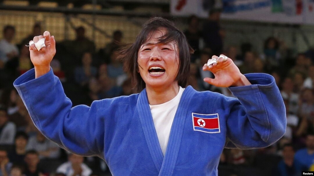 North Korea's An Kum Ae celebrates after defeating Cuba's Yanet Bermoy Acosta in their women's -52kg final judo match at the London 2012 Olympic Games July 29, 2012.