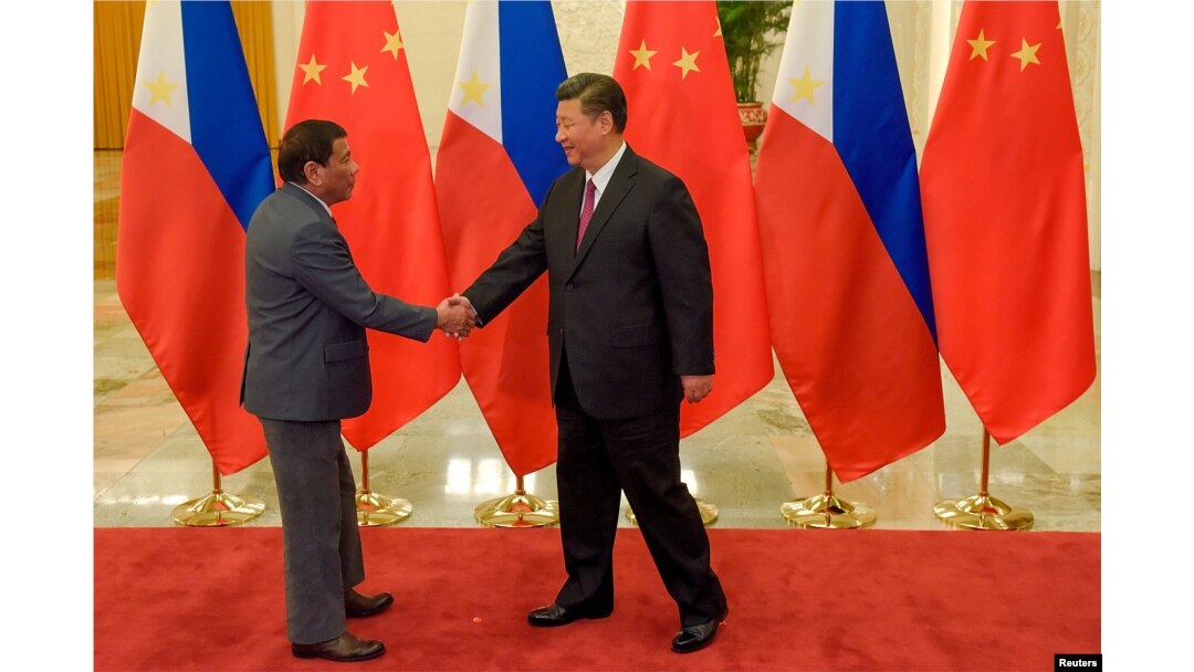 FILE - Chinese President Xi Jinping (R) shakes hands with Philippines President Rodrigo Duterte prior to their bilateral meeting during the Belt and Road Forum, at the Great Hall of the People in Beijing, China, May 15, 2017.