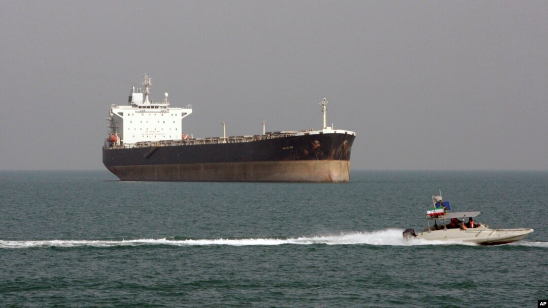 FILE - An Iranian Revolutionary Guard speedboat passes near an oil tanker, July 2, 2012.