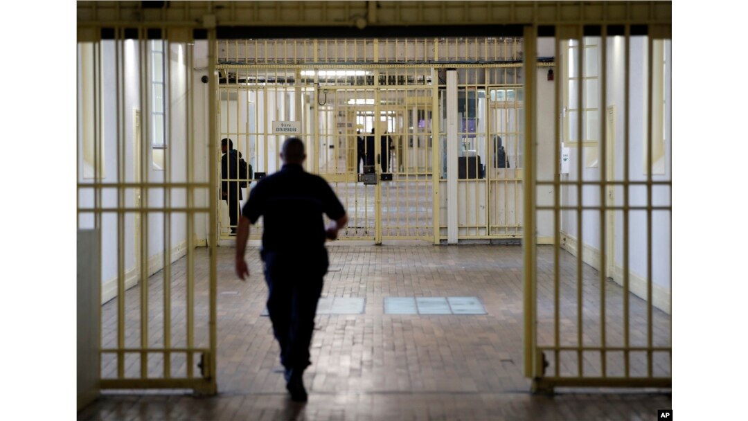 FILE - A guard walks in the corridor of Fresnes prison, south of Paris, France, Sept. 20, 2016.