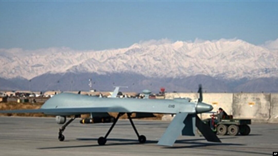 A US Predator unmanned drone armed with a missile sets off from its hangar at Bagram air base [file photo]