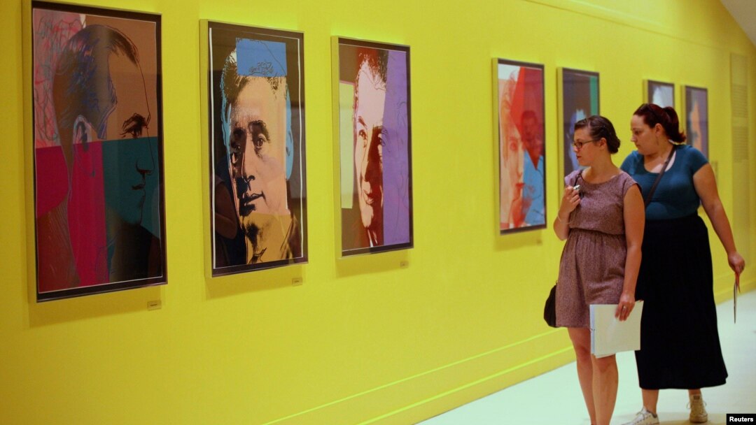 Visitors at Pera Museum in Istanbul look at artwork by Andy Warhol, June 10, 2014.