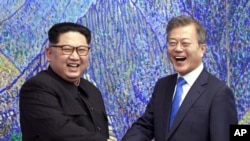 FILE - North Korean leader Kim Jong Un, left, and South Korean President Moon Jae-in inside the Peace House at the border village of Panmunjom in the Demilitarized Zone, South Korea, April 27, 2018.