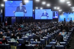 FILE - Alternative for Germany party member and co-leader Joerg Meuthen is seen on a big screen while he speaks during Germany's far-right AfD party congress, as the spread of coronavirus continues, in Kalkar, Germany, Nov. 28, 2020.