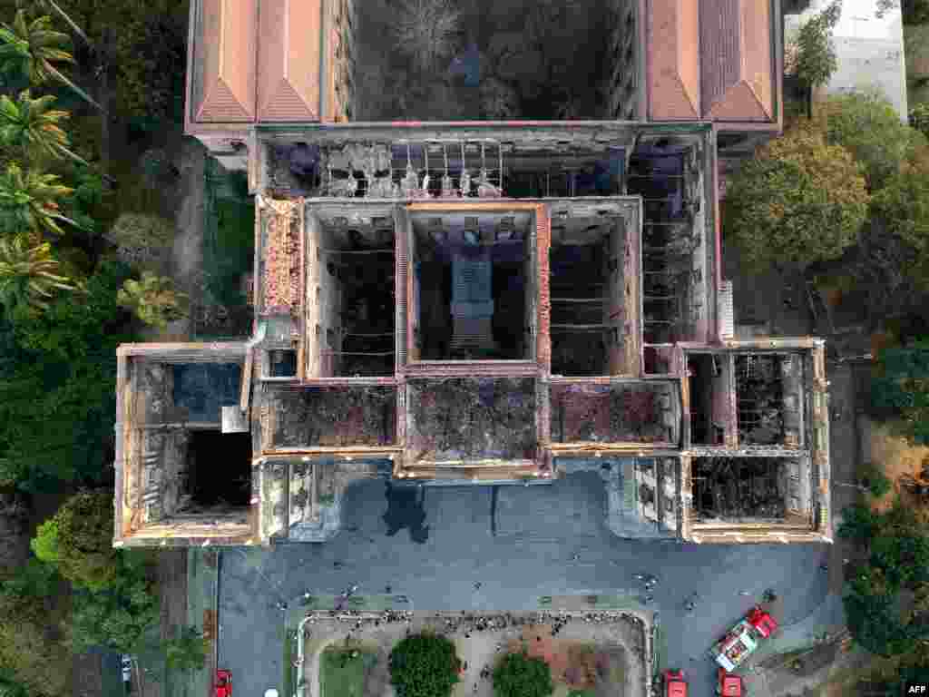 Drone view of Rio de Janeiro's treasured National Museum, one of Brazil's oldest, a day after a massive fire ripped through the building, Sept. 3, 2018. The majestic edifice stood engulfed in flames as plumes of smoke shot into the night sky, while firefighters battled to control the blaze that erupted around 2230 GMT. Five hours later they had managed to smother much of the inferno that had torn through hundreds of rooms, but were still working to extinguish it completely, according to an AFP photographer at the scene.