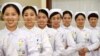 Nurses practice smiling with chopsticks in their mouths at a hospital in Handan, Hebei province, China, May 8, 2017. 