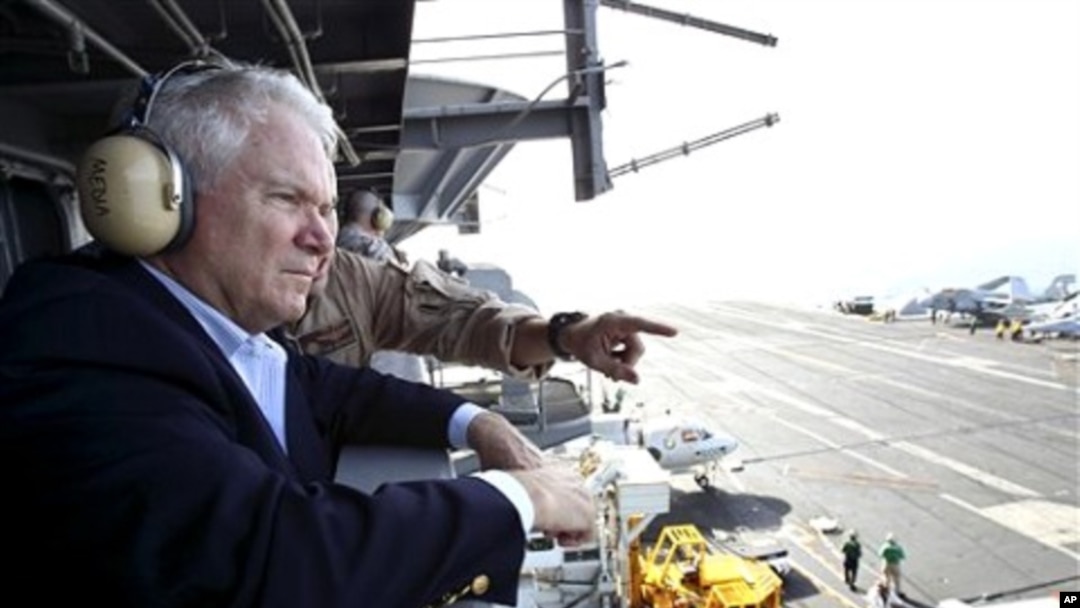 Defense Secretary Robert Gates watches flight operations aboard the USS Abraham Lincoln in the Arabian Sea', 6 Dec 2010
