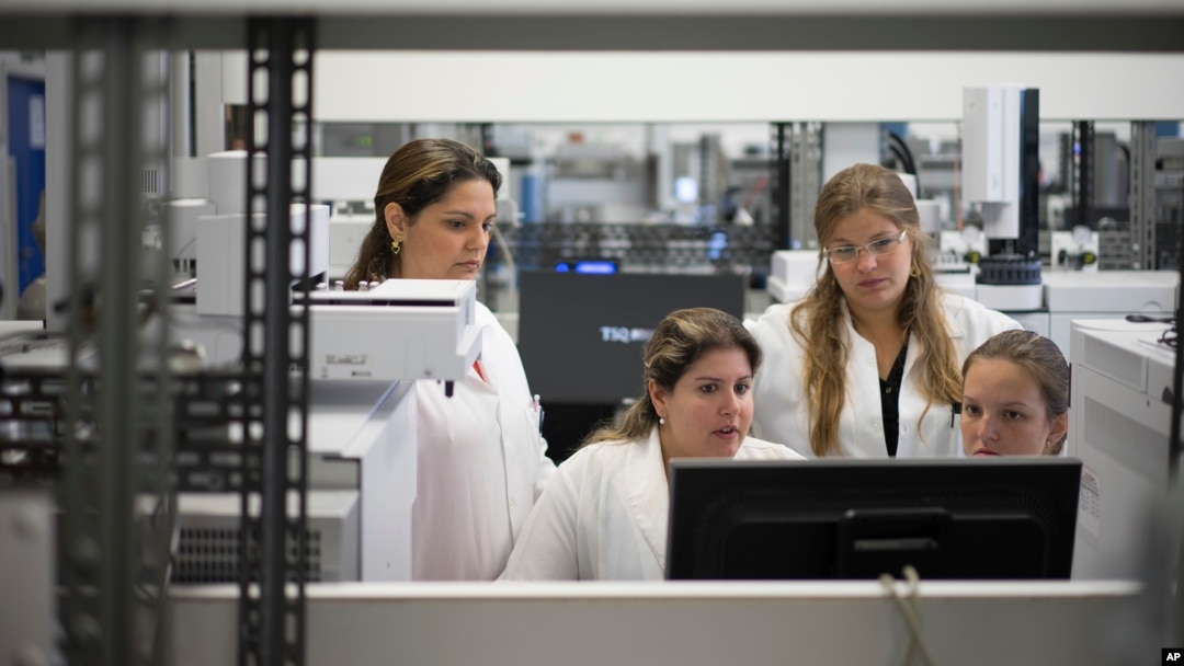 FILE - Lab technicians work at the Brazilian Doping Control Laboratory (LBCD) before a visit by Brazil's sports minister in Rio de Janeiro, Brazil, Friday, May 8, 2015.