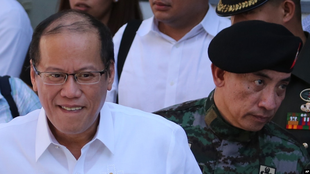 FILE - Philippine President Benigno Aquino III, left, walks with New Philippine National Police Special Action Force (SAF) head, Chief Supt. Moro Virgilio Lazo, after the Assumption of Command Ceremony at Camp Bagong Diwa, Taguig, south of Manila.