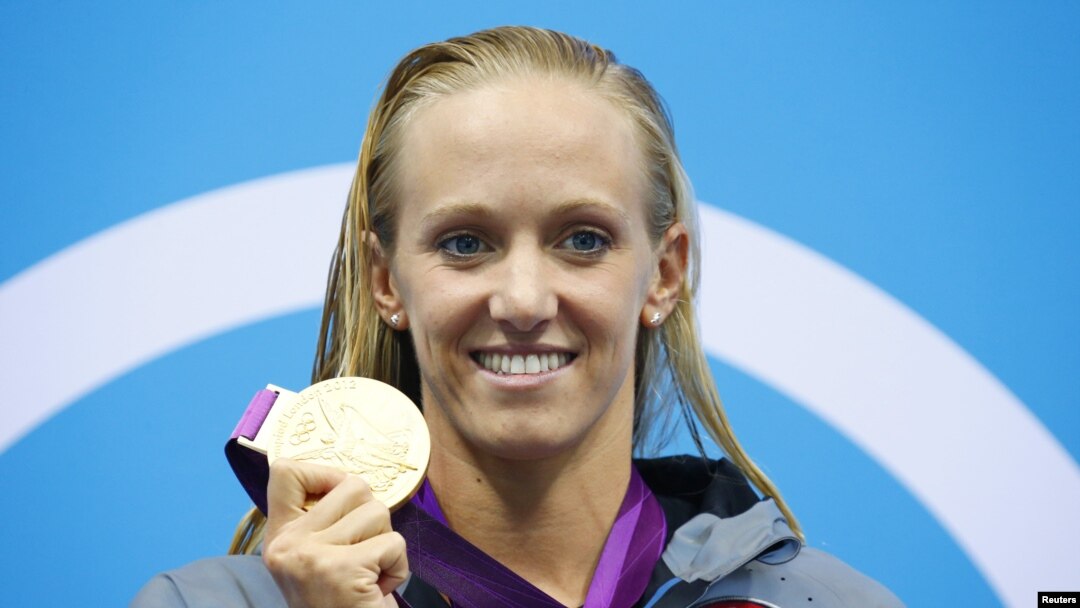 Dana Vollmer of the U.S. holds her gold medal during the women's 100m butterfly victory ceremony during the London 2012 Olympic Games at the Aquatics Centre July 29, 2012. 