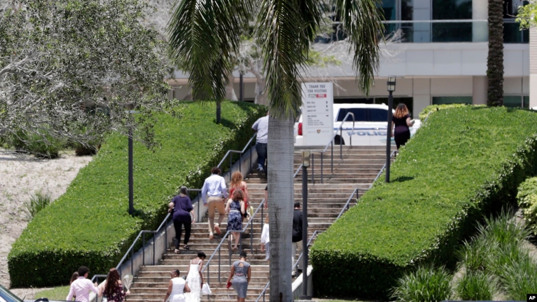 People arrive for a graduation ceremony for Marjory Stoneman Douglas High School seniors, June 3, 2018, in Sunrise, Florida. 