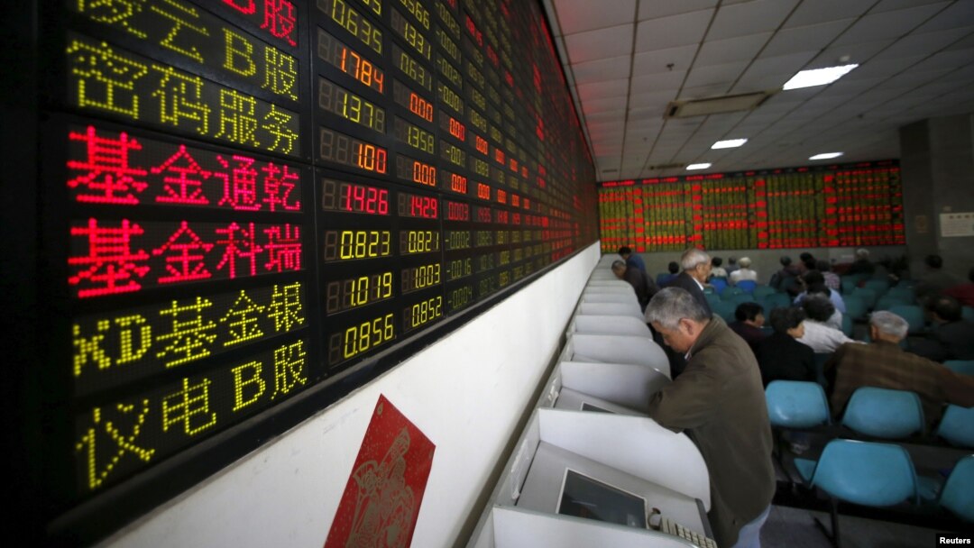 Investors look at computer screens showing stock information at a brokerage house in Shanghai, China, April 21, 2016. 