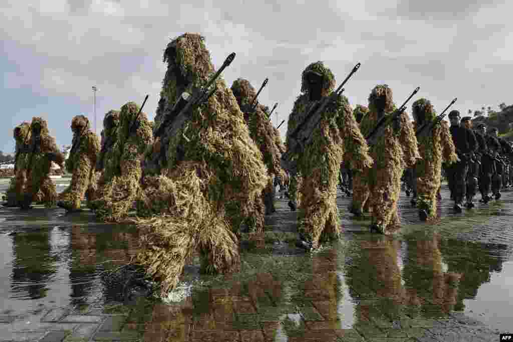 Indonesian soldiers march during a parade to mark the 73th anniversary of the Indonesian military's founding in Sabang Island, Aceh province.