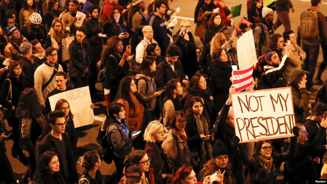 Protesters walk during a protest against Republican president-elect Donald Trump outside Trump International Hotel and Tower in Chicago, Illinois.