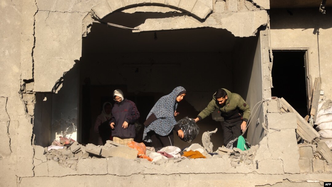 People look for salvageable items following an Israeli strike in Deir el-Balah in the central Gaza Strip on Dec. 22, 2024, amid the ongoing war between Israel and the Palestinian militant group Hamas. 