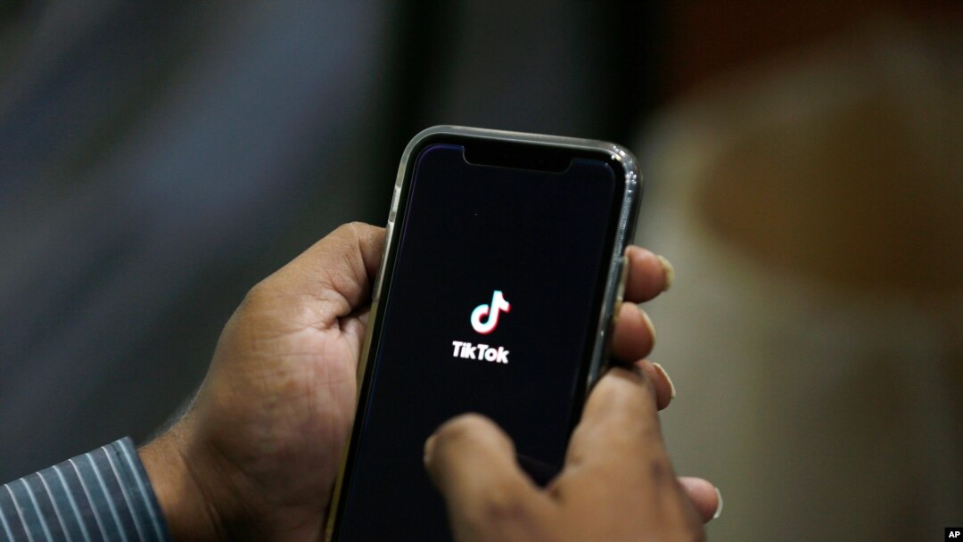 FILE - A user opens social media app TikTok on his cellphone, in Islamabad, Pakistan, July 21, 2020.