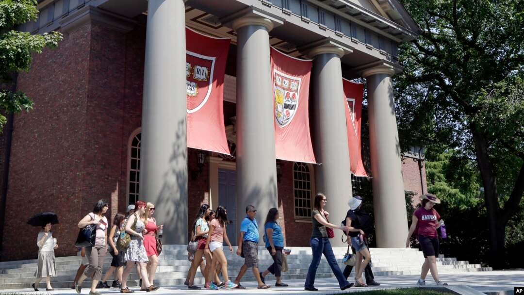 File - A tour group walks through the campus of Harvard University in Cambridge, Massachusetts. (AP Photo/Elise Amendola, File)