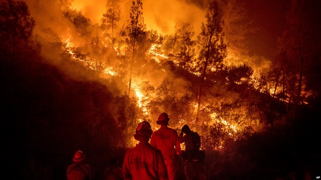 Firefighters monitor a backfire while battling the Ranch Fire, part of the Mendocino Complex Fire near Ladoga, California.