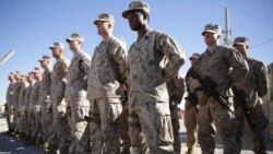 FILE - U.S. Marines watch during a change of command ceremony at Task Force Southwest military field, Helmand province, Afghanistan, Jan. 15, 2018. The final phase of ending U.S. military involvement in Afghanistan began May 1, 2021.