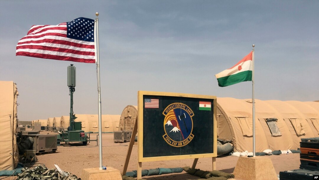 In this photo taken April 16, 2018, a U.S. and Niger flag are raised at the base camp for air forces and other personnel supporting the construction of Niger Air Base 201 in Agadez, Niger. On the edge of the Sahara Desert, the U.S. is building a base for