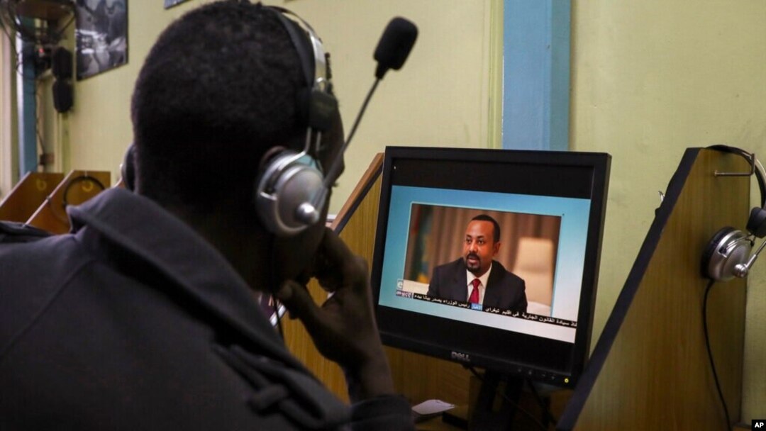 FILE - An Ethiopian streams a video of Prime Minister Abiy Ahmed speaking, at an internet cafe in Addis Ababa, Ethiopia, Nov. 26, 2020. Journalists say a government-imposed blackout in Ethiopia has made it difficult to document the fighting in Tigray. 