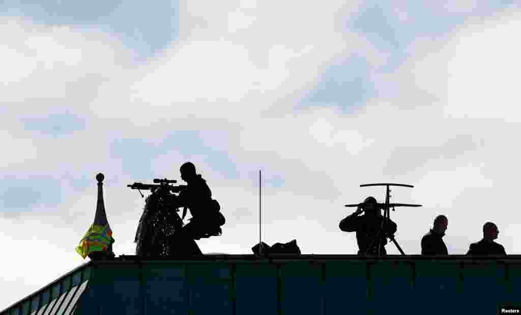 Snipers take positions on the rooftop of the Adlon Hotel before the arrival of Turkish President Recep Tayyip Erdogan in Berlin, Germany.