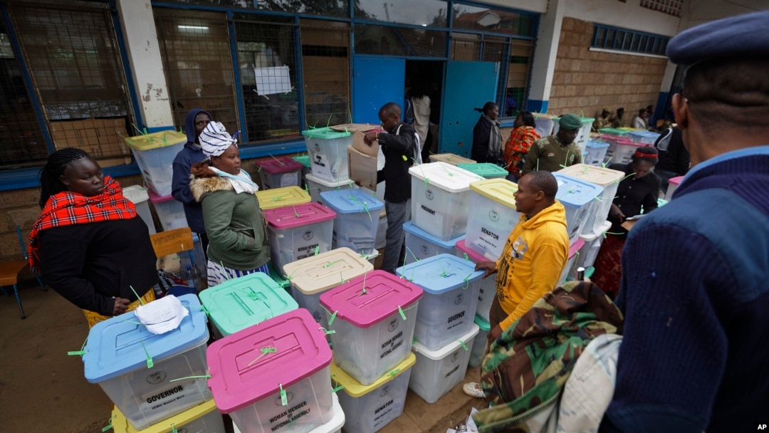 Electoral workers stand by ballot boxes stacked at a collection center in Nairobi, Kenya, Aug. 9, 2017. 