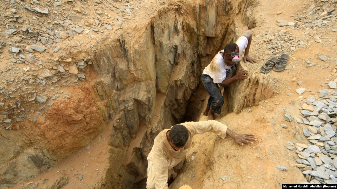 FILE - Gold mine workers climb out from a local mine in Sudan, July 30, 2013. Authorities reported a gold mine collapse March 31, 2023, near the Egyptian border that left 14 workers dead and many others injured.