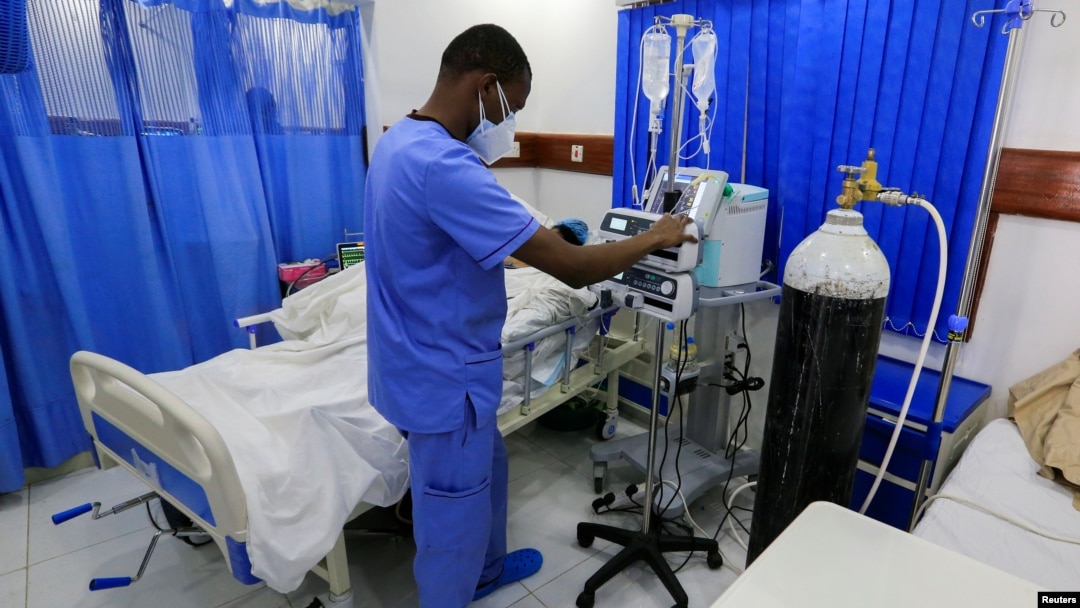 FILE - A health care worker attends to a COVID-19 patient inside the Intensive Care Unit ward equipped with supplemental oxyden, at the Care Hospital, Nairobi, Kenya, Aug. 4, 2021. 